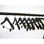 Black wooden hangers with clips