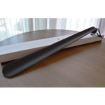 Large shoe horn covered in carbon fiber leather